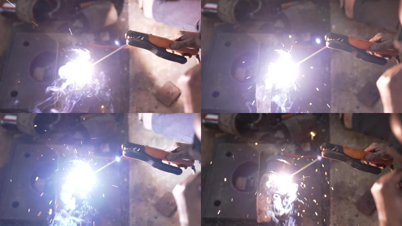 4K 50fps，焊接钢的特写，焊接机的热量拼接在轻轻焊接的钢板上产生的光，从而产生火花。