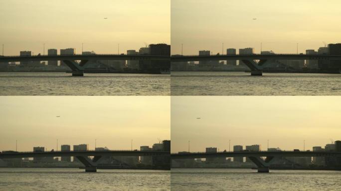 飞机在黄昏时飞过桥