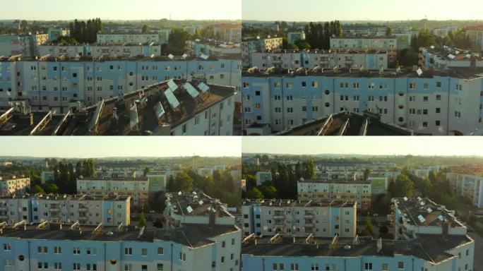 现代欧洲城市公寓楼平屋顶上的太阳能电池板。安装在住宅建筑物屋顶上的太阳能电池板的鸟瞰图。可再生生态绿