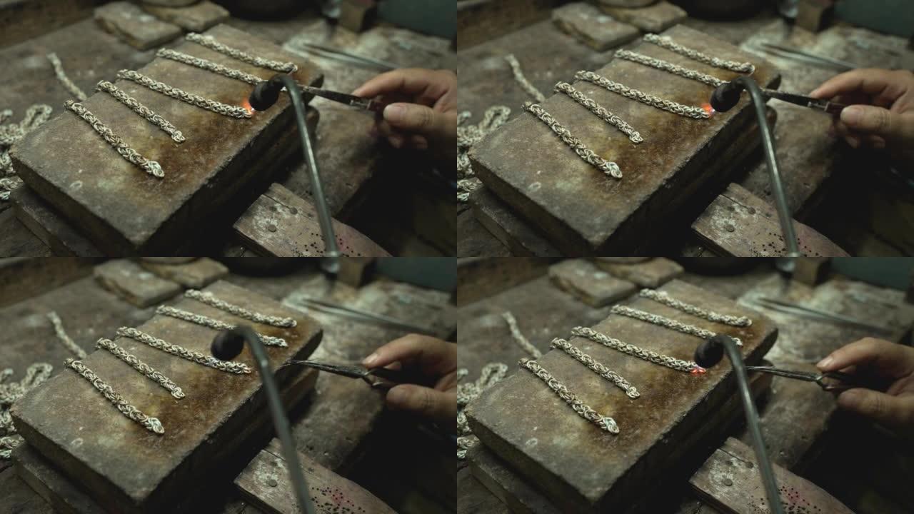 珠宝商在珠宝行业工作。用专业工具制作工艺珠宝的桌面。工具的特写视图。泰国。