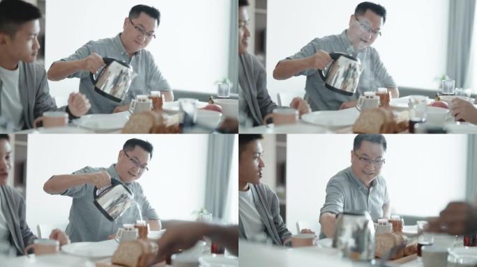 亚洲中国男性在周末为在公寓厨房享用早餐的朋友倒热水煮咖啡