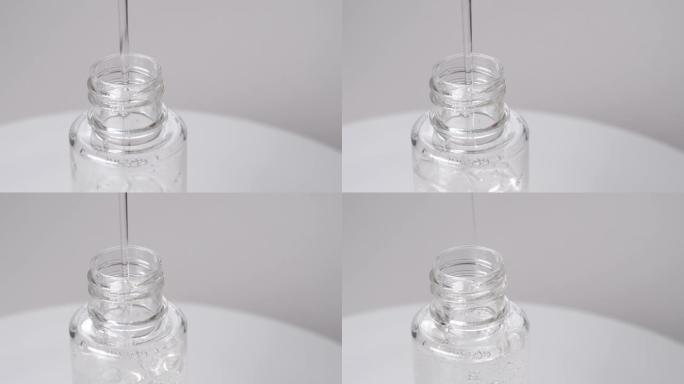 瓶子的特写镜头，倒透明液体。凝胶流入塑料容器，视频4k分辨率