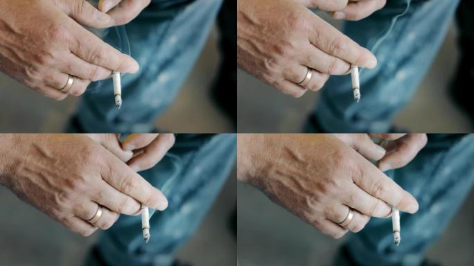 一名男子手里拿着一支吸烟的香烟。不良生活方式和不良习惯。在吸烟者手中抽烟。
