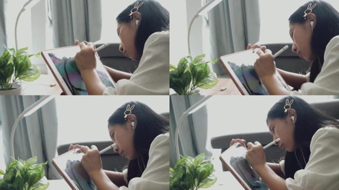 亚洲女孩用数字平板电脑和铅笔在家里窗户附近的日本折叠桌上做作业，生活方式理念。