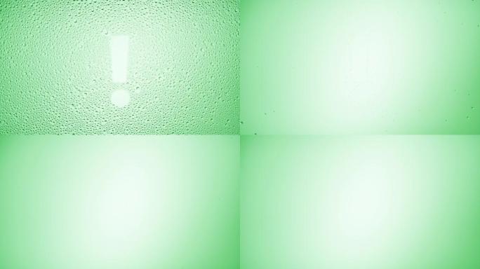 绿色背景上湿玻璃上的感叹号吹落