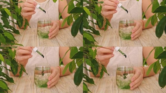 液体叶绿素在一杯水中。选择性聚焦。自然。