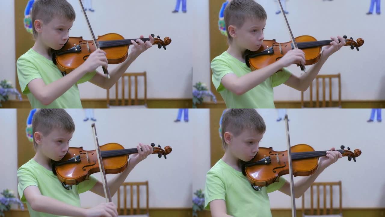 小学生青少年儿童在学校音乐课上拉小提琴。