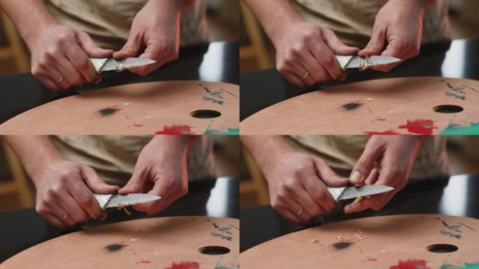 艺术家用切刀削木铅笔，刨花落在画家的调色板上。ProRes编解码器。特写