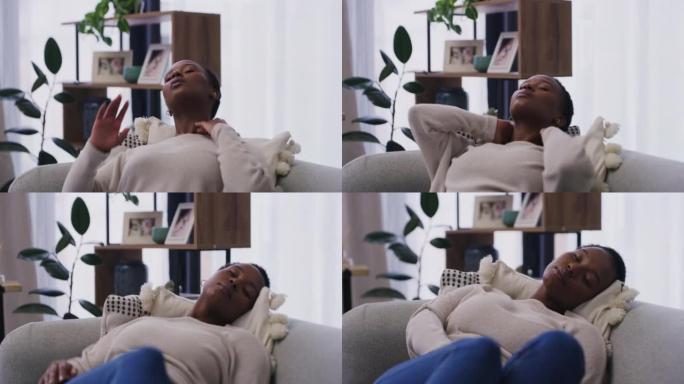 患有颈部疼痛的年轻非洲裔美国妇女在家里的沙发上小睡。一名20多岁的黑人妇女在试图在家休息时颈部疼痛。