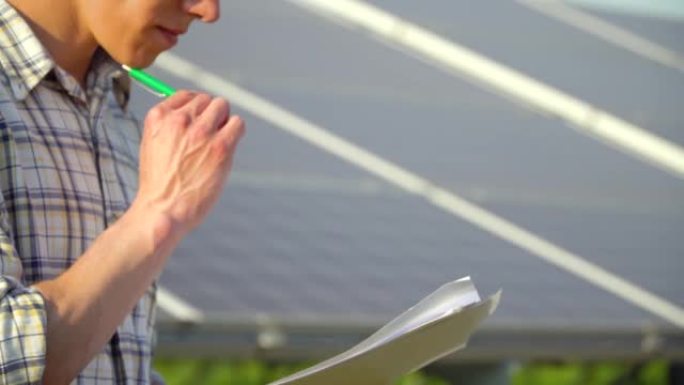 工程师手的特写检查太阳能电池板的生产率