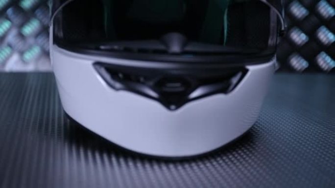 近距离拍摄金属地板上的白色摩托车全脸头盔。