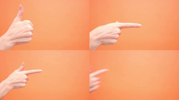 女人在孤立的红色背景上抬起拇指，然后将食指指向4k。手势，工作室。广告。批准。好心情，支持，国际签