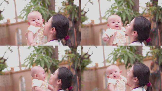 可爱，新生的亚洲男婴。家庭幸福，亚洲年轻的母亲在玩耍，带着爱，带着爱，带着幸福的笑容。小无辜的新生婴