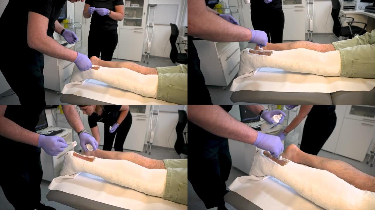 男性高加索骨科医生，将伤口包扎到一名青少年患者身上