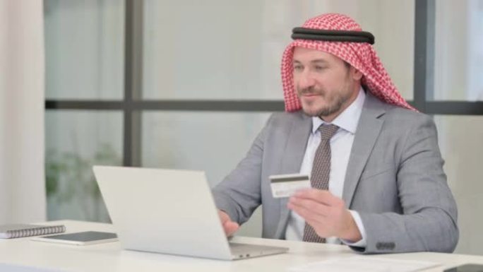 Arab Businessman making Successful Online Payment 