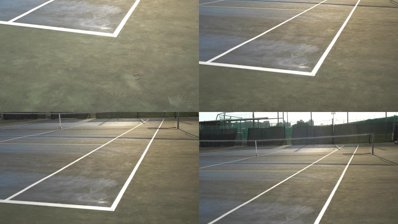 室外的旧网球场。日落时。