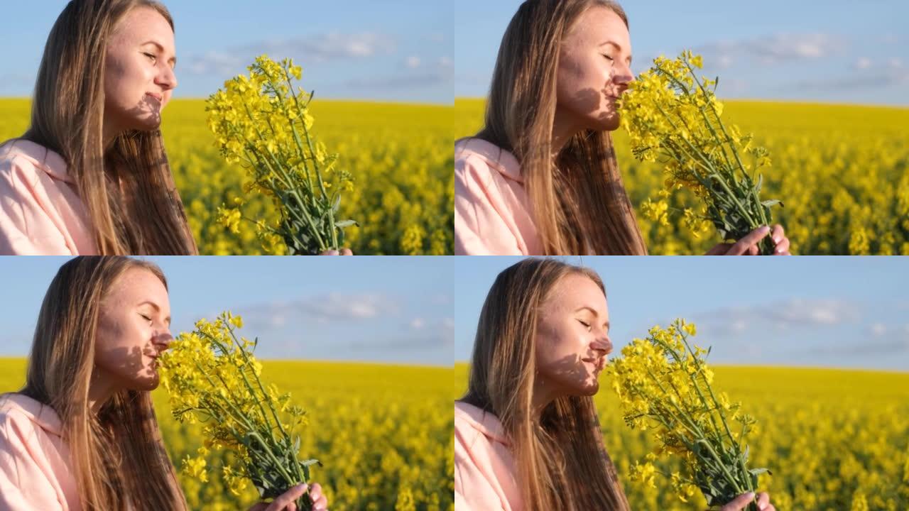 年轻漂亮的女孩在油菜籽地上捧着一束黄色的花束。手上长花