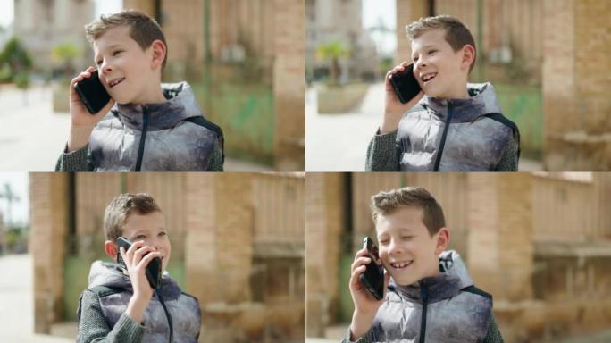金发碧眼的孩子微笑着自信地在街上的智能手机上交谈