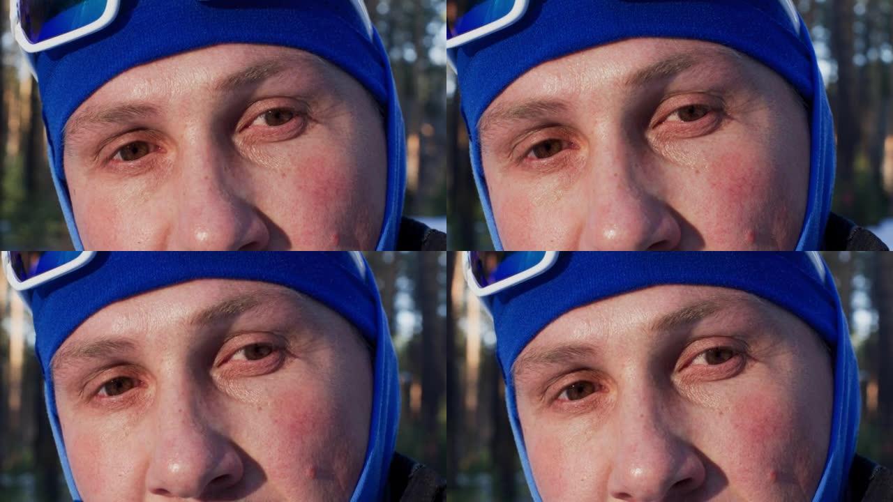 戴着滑雪面具的沉思男子看着相机的特写镜头
