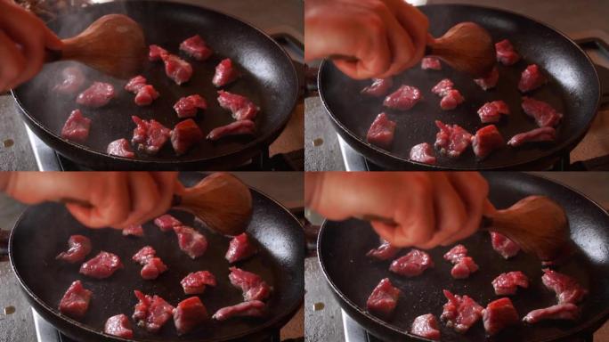 慢动作在锅里煮小块肉溅油