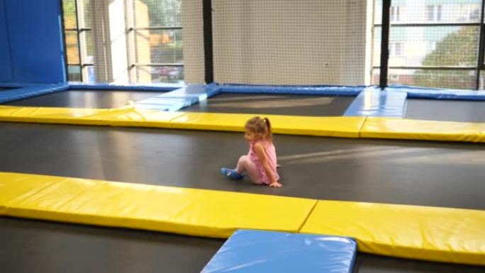 小女孩在蹦床游乐园游乐场嬉戏跳跃和滚动