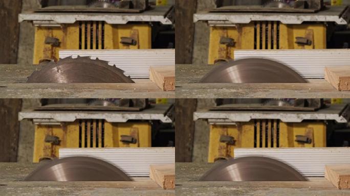 亚洲木匠正在用圆锯切割木材，以制造新的家具。带硬质合金齿的圆锯片在车间工作，有选择性聚焦的特写镜头。