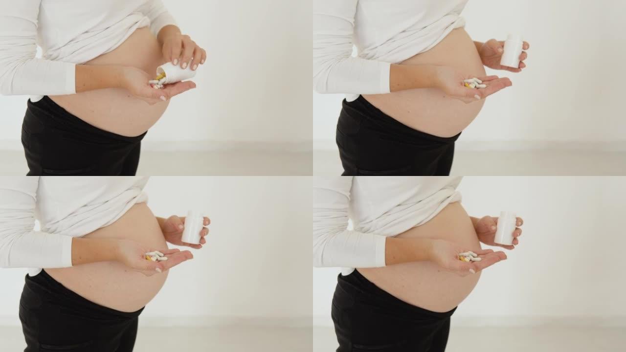 皮肤白皙的孕妇站在白色背景上，将药丸倒在手掌上