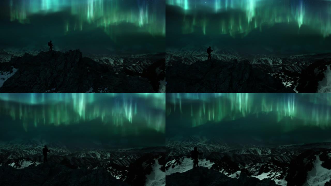 男子在冰山全景上的冰岩山顶上看着北极光北极光。