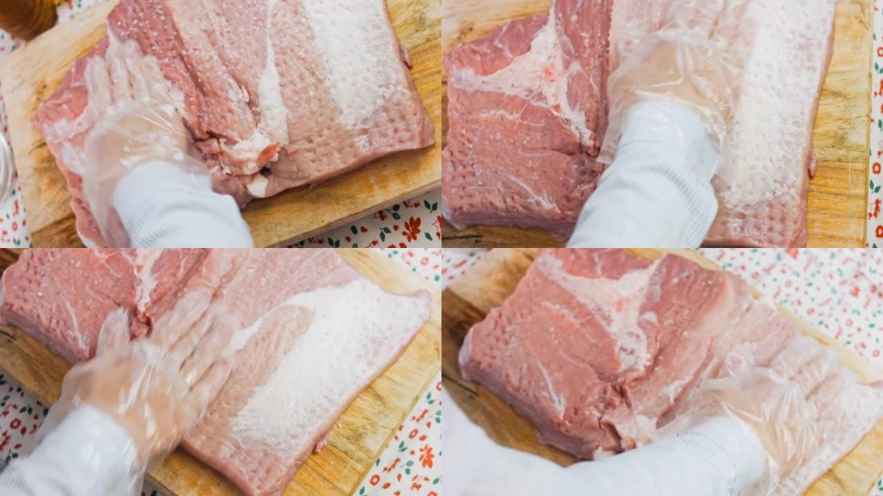 厨师用海盐将猪肉腌制