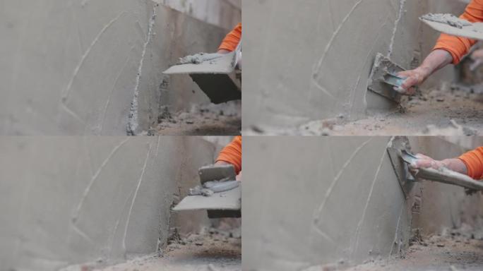 建筑工人抹灰墙面。