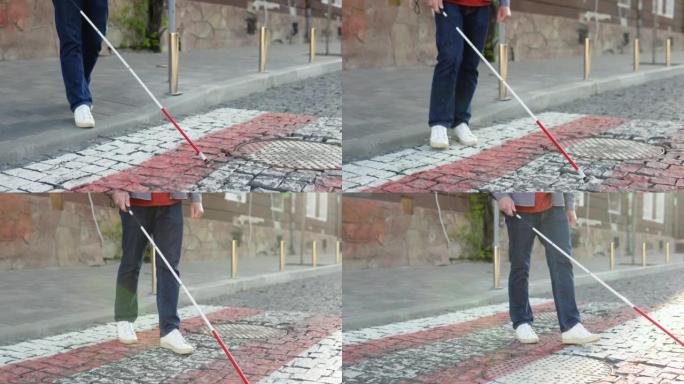 一个拐杖的盲人过马路