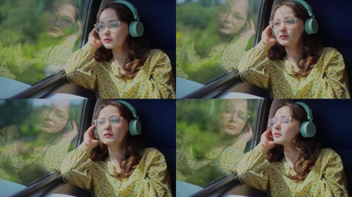女人在火车上旅行，戴着耳机听音乐
