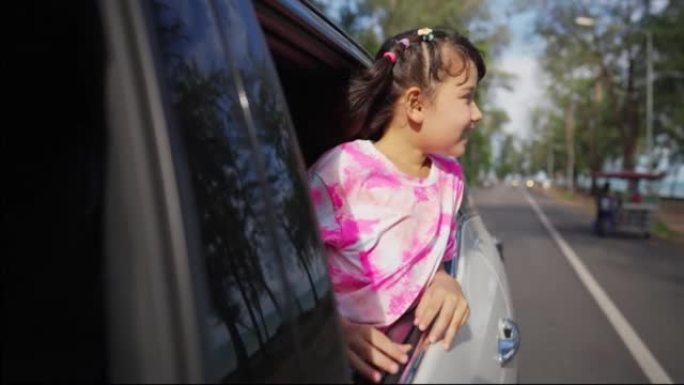 4k快乐的亚洲小女孩在夏季公路旅行假期中与家人一起享受和娱乐。