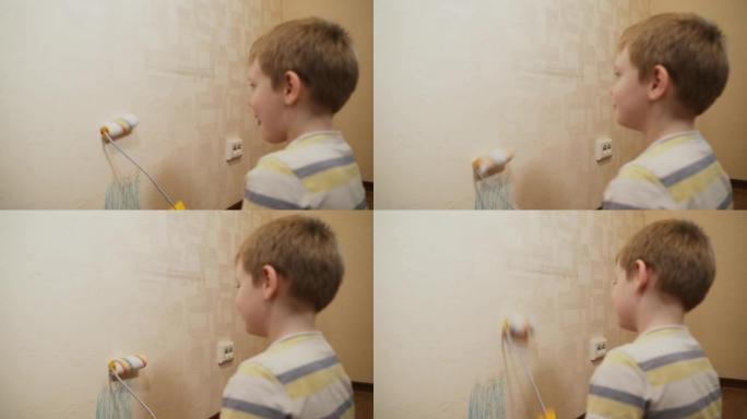 高加索儿童，男孩在墙上滚动油漆滚筒，玩耍