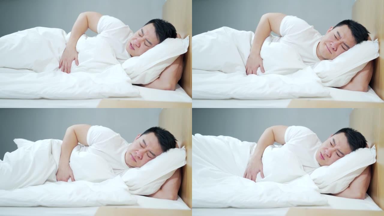 年轻患病的亚洲男子腹痛严重，胃痛中毒。早上躺在床上在家受苦