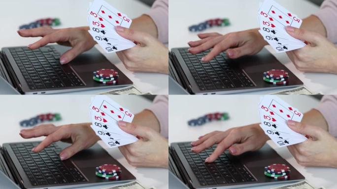 人与笔记本电脑扑克牌的赌场筹码堆一起工作