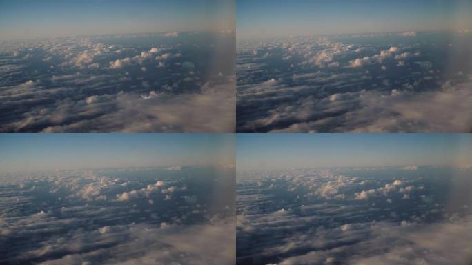 飞机窗口的日落云飞云之上飞机窗外