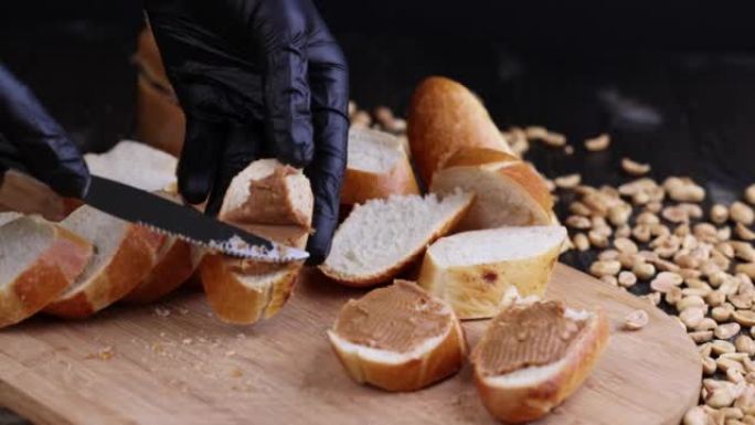 在新鲜的白色法式长棍面包上撒上花生酱和坚果