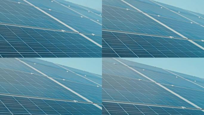 安装在建筑物屋顶上的蓝色光伏太阳能电池板表面的特写镜头，用于产生清洁的生态电力。可再生、替代和可持续