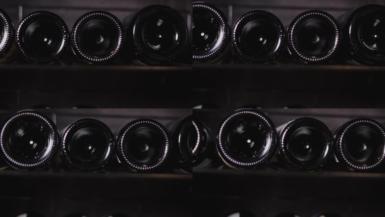 用相机关闭，在酒窖中移动4k的许多葡萄酒瓶，看到餐厅收藏的架子和成排的豪华红酒，用于庆祝和节日。