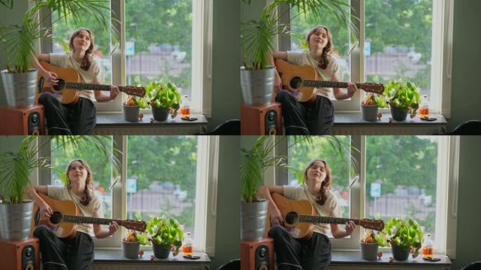 女人坐在窗台上弹吉他
