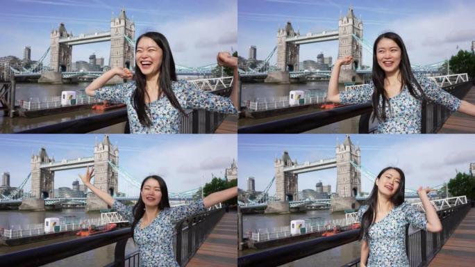 一名年轻女子在伦敦塔桥跳舞并享受生活