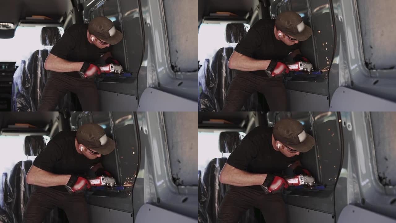 在货车上安装窗户时使用研磨机电动工具的人