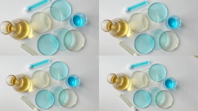 实验室玻璃器皿，实验室桌上有黄色和蓝色液体