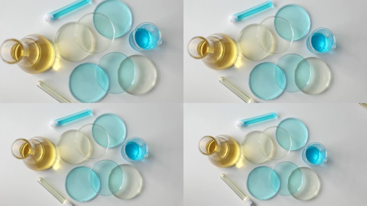 实验室玻璃器皿，实验室桌上有黄色和蓝色液体