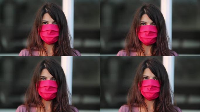 用红脸面具遮盖嘴的女人肖像