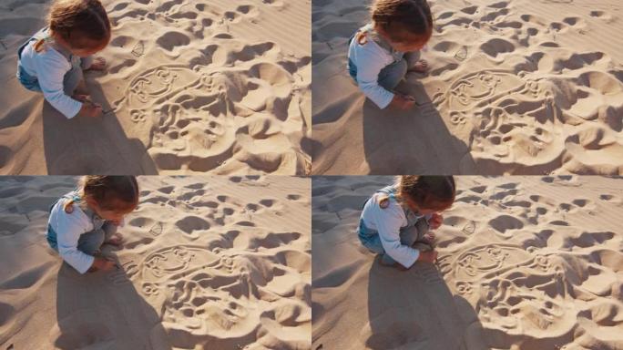 蹒跚学步的女孩在沙滩上画画