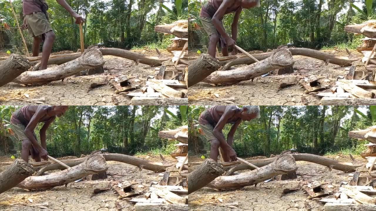 印度乡村体力劳动者用斧头劈柴或砍柴，用斧头劈柴。