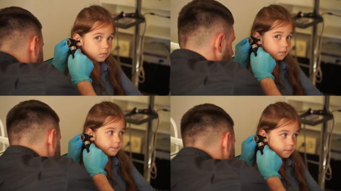 带耳镜的4k视频耳鼻喉科医生。耳镜检查。儿科医生耳鼻喉科医生通过耳镜观察孩子的耳朵。耳镜检查。治疗耳