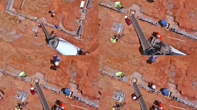 这张鸟瞰图，工人们在施工现场的新建筑中浇筑混凝土柱